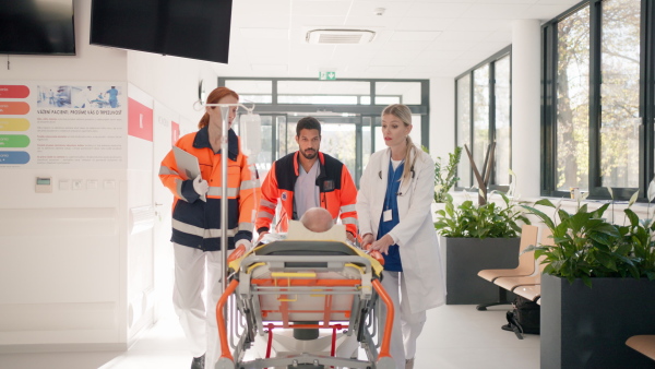 Young woman doctor taking care of patient from a rescue ambulance.