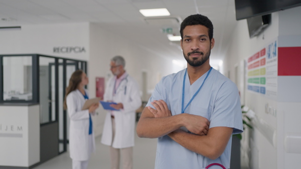 Close-up of young multiracial doctor standing at a hospital corridor.