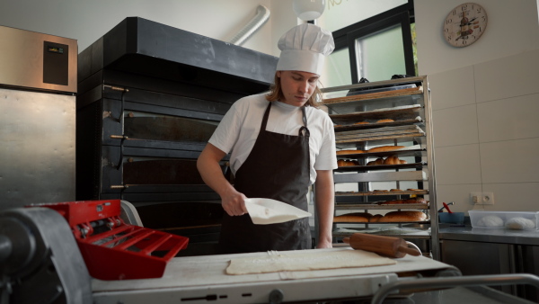 Video of young baker preparing pastries in a bakery.