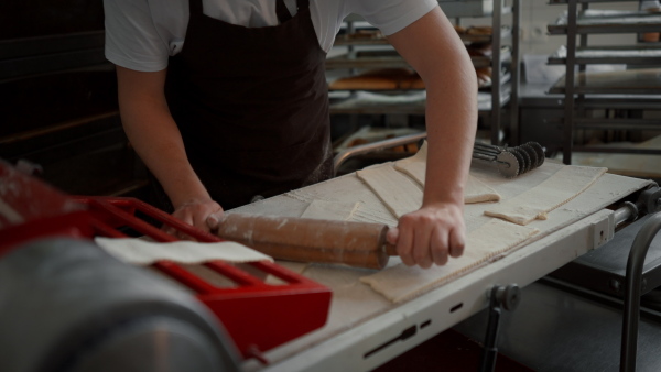 Video of young baker preparing pastries in a bakery.