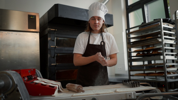 Video of young baker preparing pastries in a bakery.