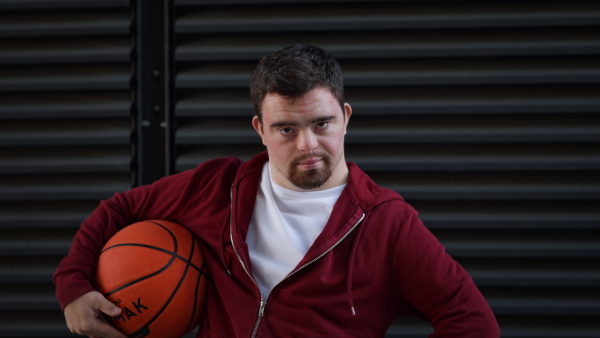 Video of young man with down syndrom holding a basketball ball.