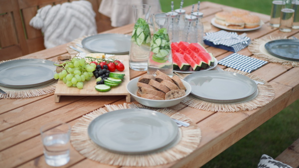 A dining table set for dinner on the terrace in summer, garden party concept.