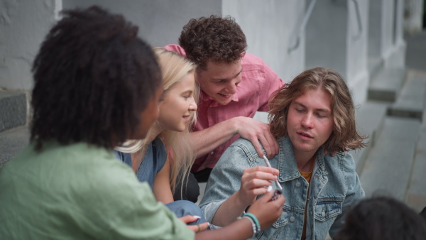 A young teenager smoking marihuana cigarettes. Social problems, addiction concept.