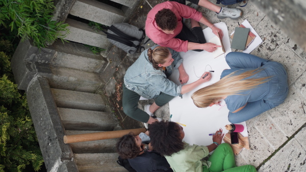 A vertical footage of group of teenager students making a peace poster.