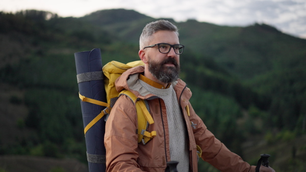 Portrait of male hiker enjoying view in nature on early morning.