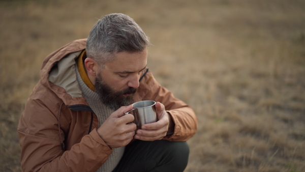 Enjoying his coffee in peace and calm natural environment.