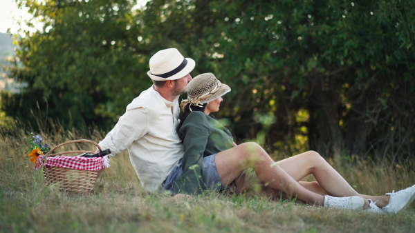 A happy family hugging together during picnic in nature.