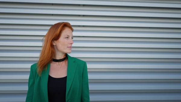 Close-up of redhead woman looking at the camera.