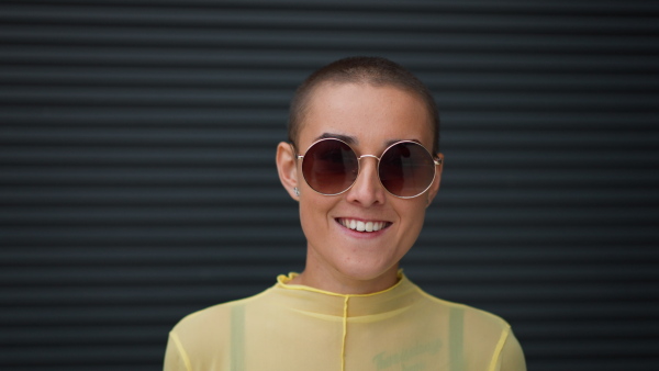 Close-up of woman with sunglasses looking at the camera.