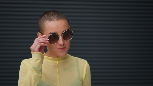 Close-up of woman with sunglasses looking at the camera.