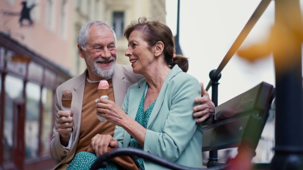 Elegant senior couple in love dating, having an ice cream.