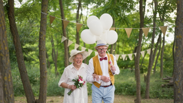 Senior couple having marriage in nature during a summer day.