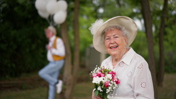 Senior couple having marriage in nature during a summer day.