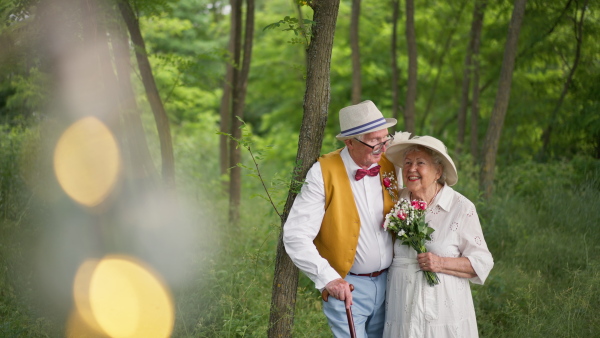 Senior couple having marriage in nature during a summer day.