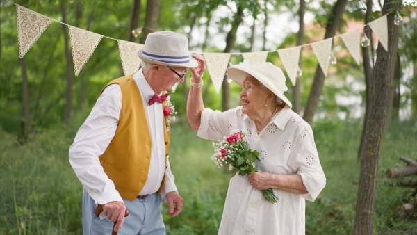 Senior couple having marriage in nature during a summer day.