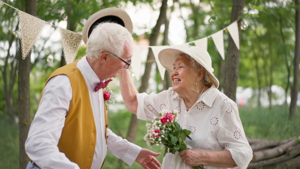 Senior couple having marriage in nature during a summer day.