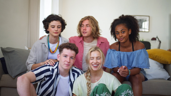 A diverse group of friends with mixed races having fun together and taking selfie indoors, Friendship and lifestyle concepts