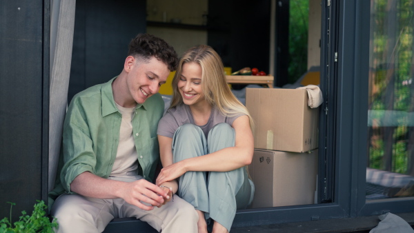 A cheerful young couple in their new apartment. Conception of moving.