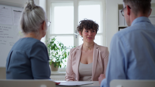 A young woman talking at a job interview.