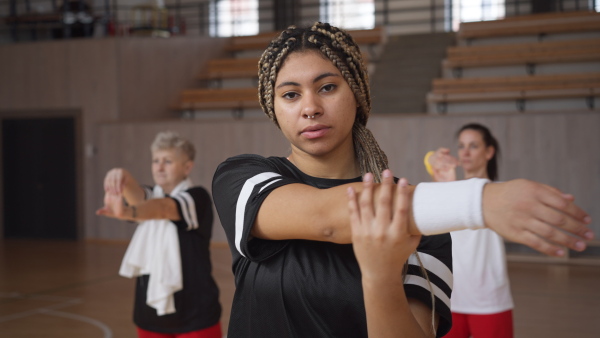 A group of young and old women, sports team players in gym, doing work out exercise.