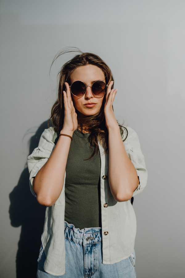 Portrait of happy young woman outdoor with a sunglasses.