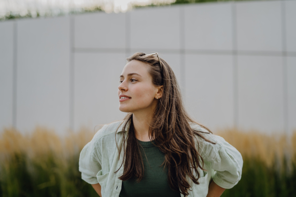 Portrait of happy young woman outdoor in city park with a sunglasses.