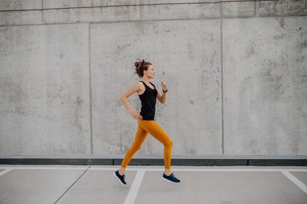 Young woman jogging in city, healthy lifestyle and sport concept.