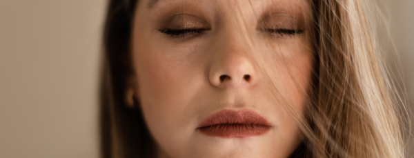 Portrait of young beautiful woman with closed eyes and natural make up.