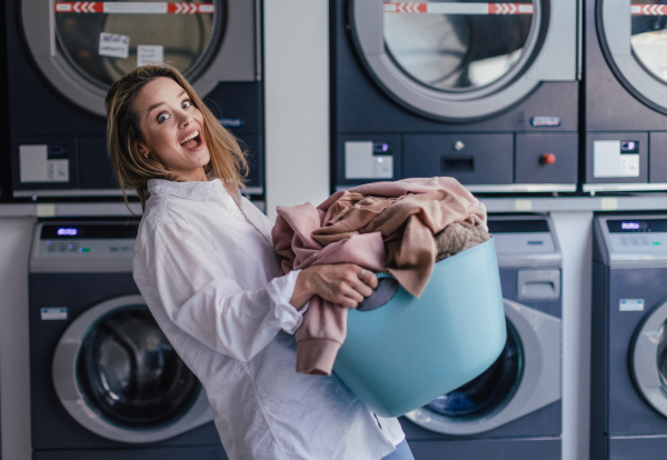 Young woman waiting in the laundry room.