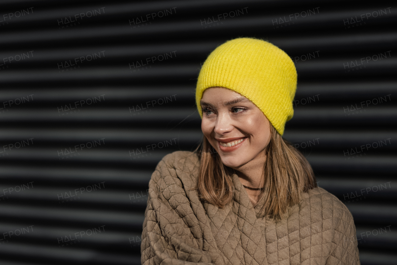 Portrait of young fashionable woman in city.