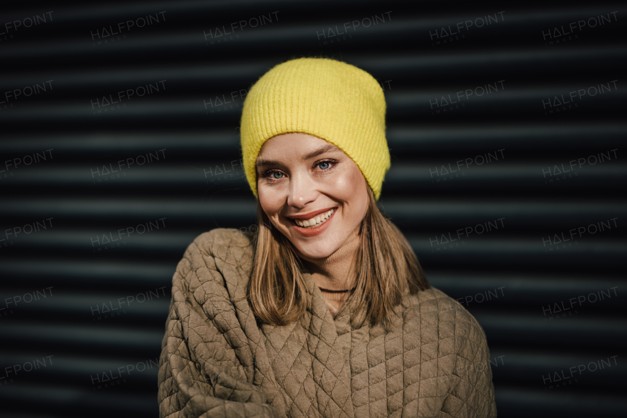 Portrait of young fashionable woman in city.