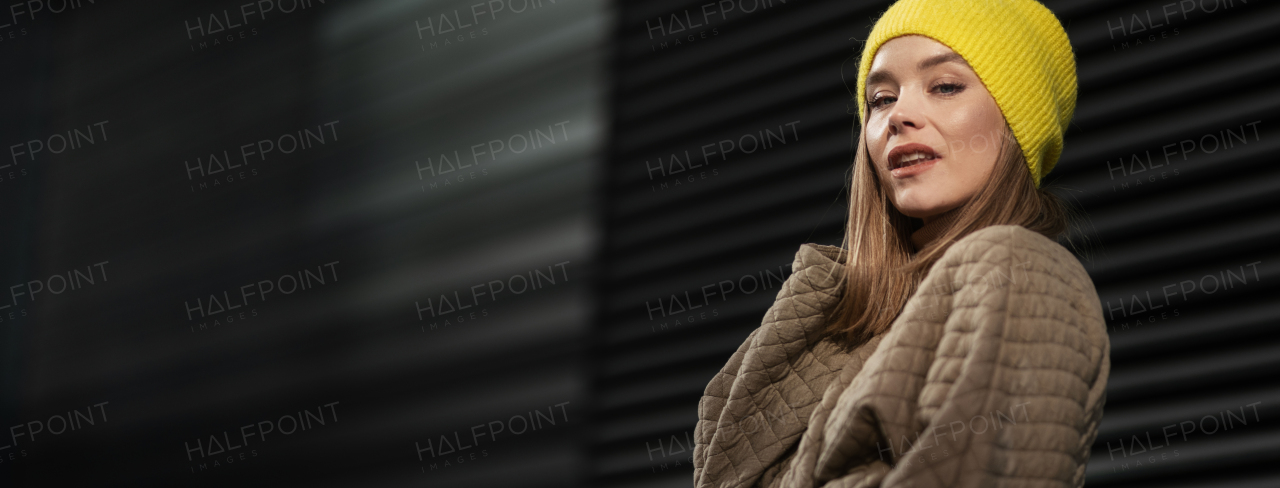 Portrait of young fashionable woman in city.