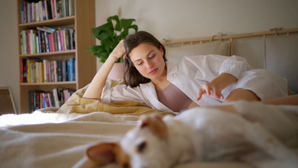 Beautiful woman reading book in bed, cozy feeling. Freedom, weekend activity for single woman.