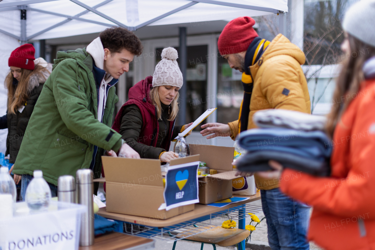 The volunteers distributing dontaions to refugees on the Ukrainian border, Russian-Ukrainian war concept.