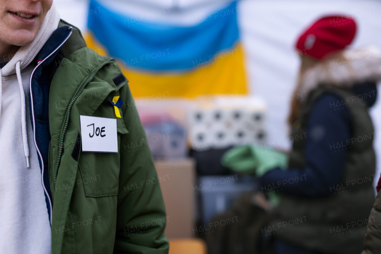 The volunteers distributing food and drink to refugees on the Ukrainian border, humanitarian aid concept.