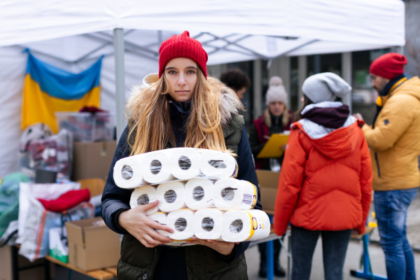 The volunteers distributing dontaions to refugees on the Ukrainian border, Russian-Ukrainian war concept.