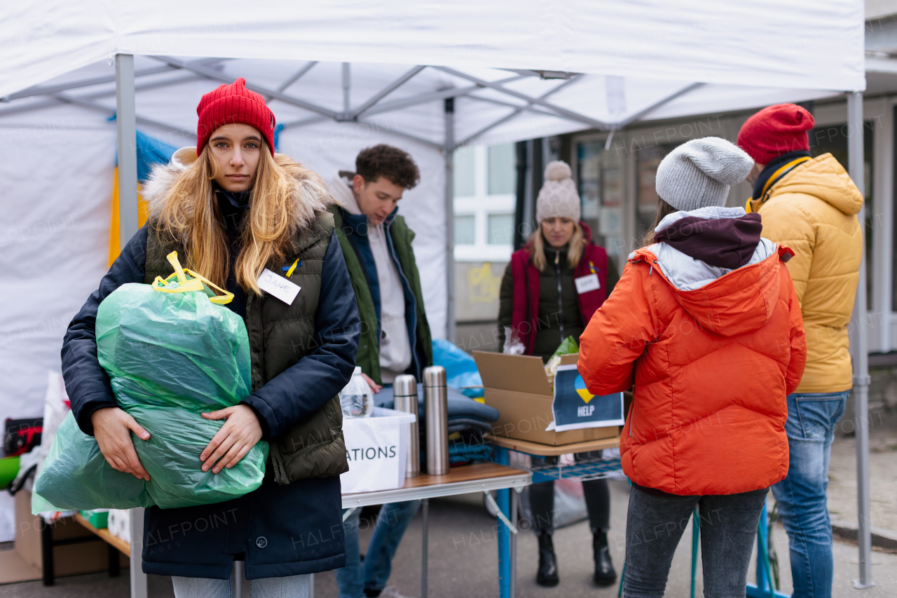 The volunteers distributing dontaions to refugees on the Ukrainian border, Russian-Ukrainian war concept.