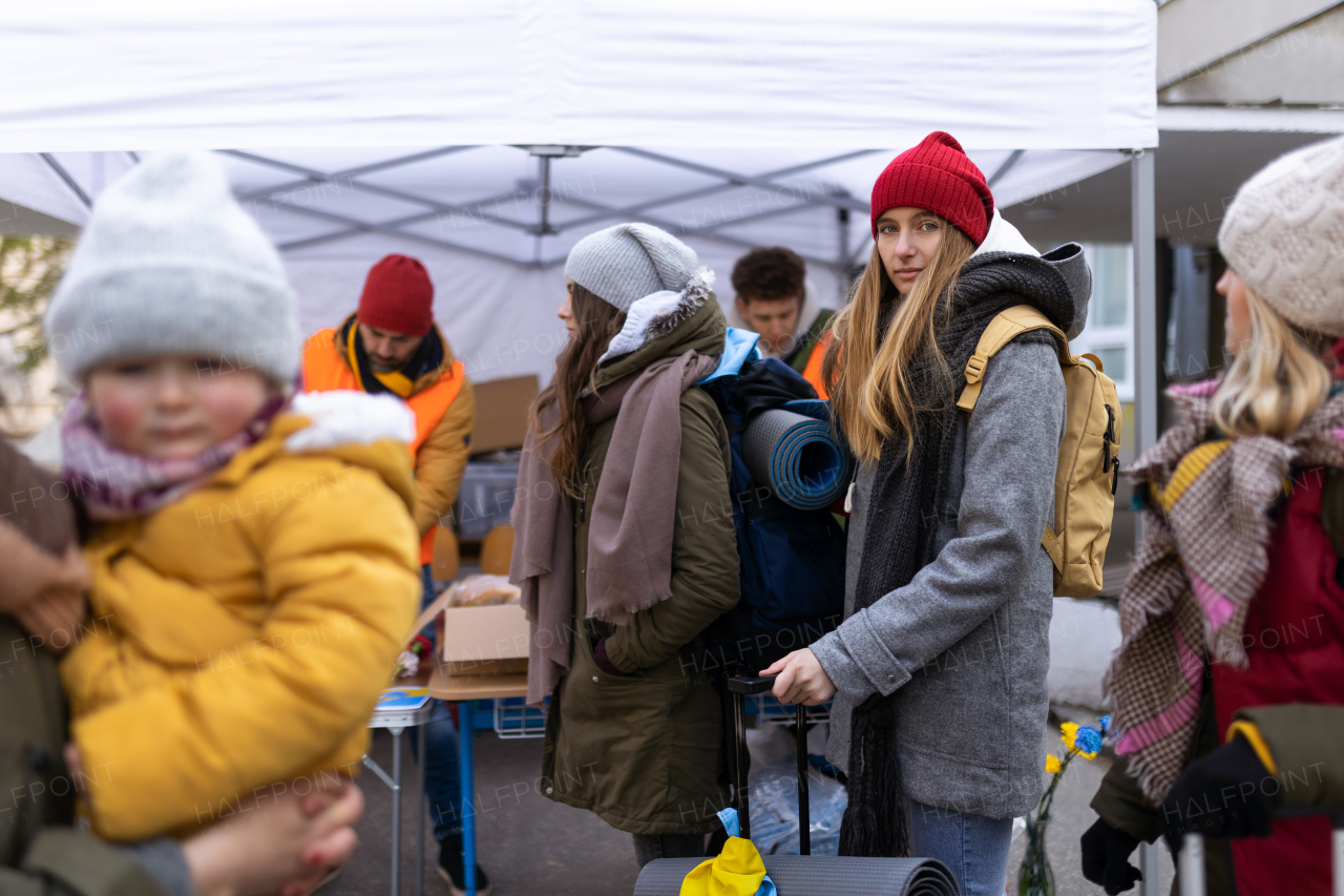 The Ukrainian immigrants crossing border and getting donations from volunteers, Ukrainian war concept.