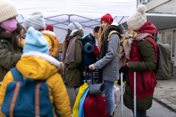 The Ukrainian immigrants crossing border and getting donations from volunteers, Ukrainian war concept.