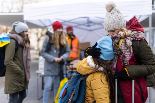 The Ukrainian refugee mother with child crossing border.