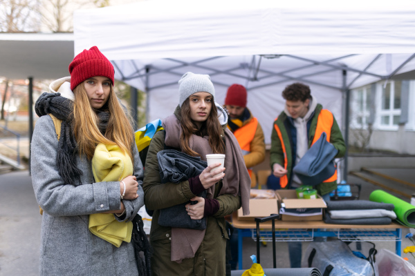 The Ukrainian immigrants crossing border and getting donations from volunteers, Ukrainian war concept.