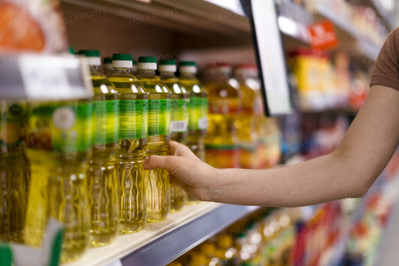 A woman buying cooking oil in supermarket