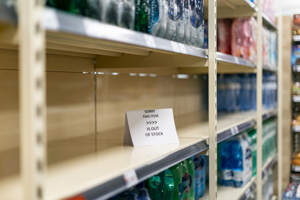 Empty shelves in a grocery store with sold out goods