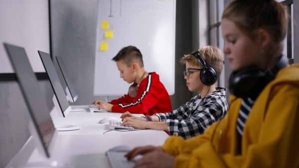 School kids using computer in a classroom at school