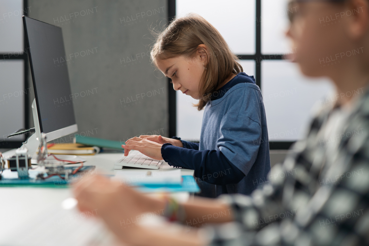 School kids using computer in a classroom at school