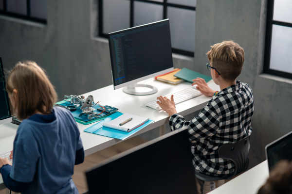 High angle view of school kids using computer in a classroom at school