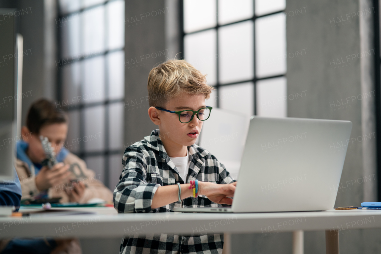 School kids using computer in a classroom at school