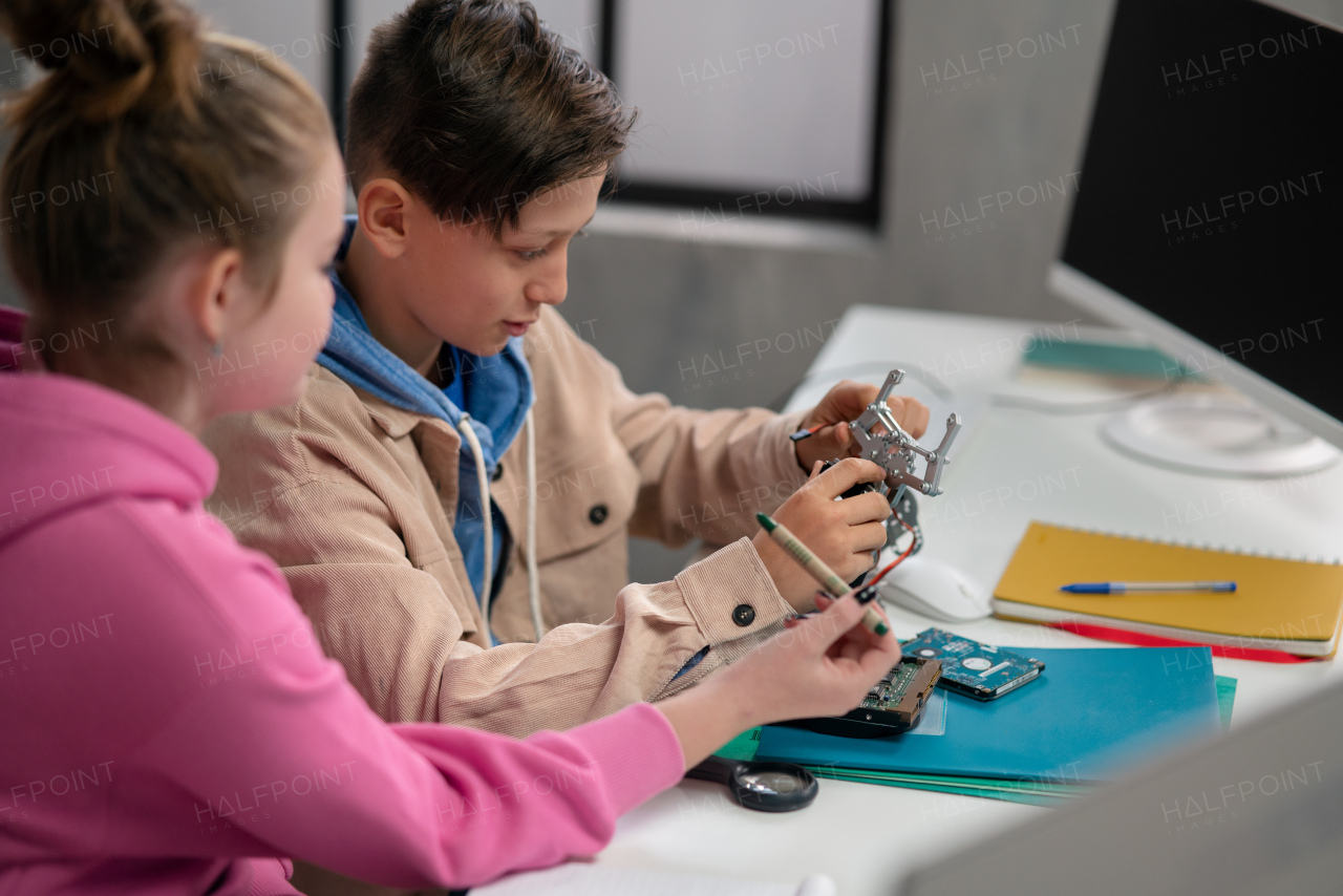 Pupils at school working with electronics component at a robotics classroom.