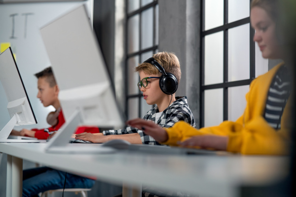 School kids using computer in a classroom at school